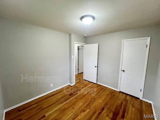 170 Ruth Dr, Florissant, MO 63031 - unfurnished bedroom featuring wood finished floors and baseboards
