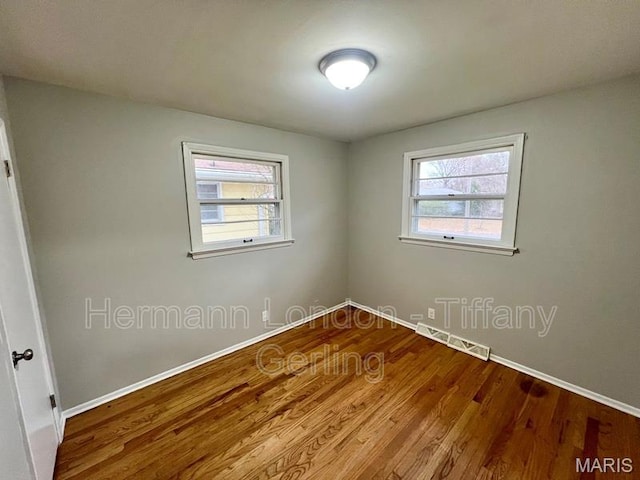 170 Ruth Dr, Florissant, MO 63031 - empty room featuring baseboards, healthy amount of natural light, and wood finished floors