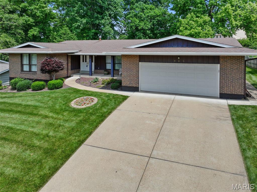305 Morewood Dr, Manchester, MO 63011 - single story home with a front lawn, driveway, brick siding, and an attached garage