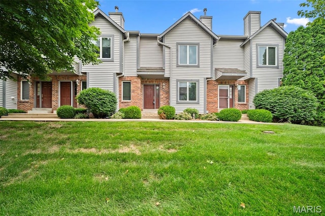 4505 Sherman Park Dr, Saint Charles, MO 63303 - townhome / multi-family property featuring a chimney, brick siding, and a front lawn