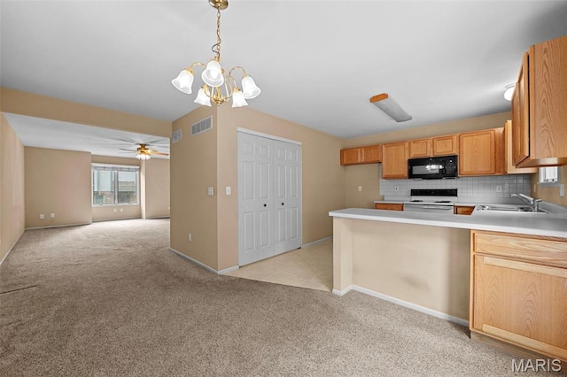 4505 Sherman Park Dr, Saint Charles, MO 63303 - kitchen with white electric stove, black microwave, a sink, light carpet, and tasteful backsplash