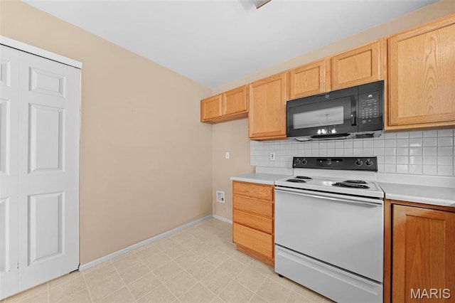 4505 Sherman Park Dr, Saint Charles, MO 63303 - kitchen featuring white electric range oven, black microwave, light countertops, and backsplash
