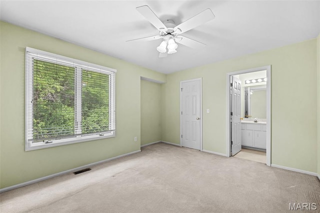 4505 Sherman Park Dr, Saint Charles, MO 63303 - unfurnished bedroom featuring light carpet, baseboards, connected bathroom, a ceiling fan, and a sink