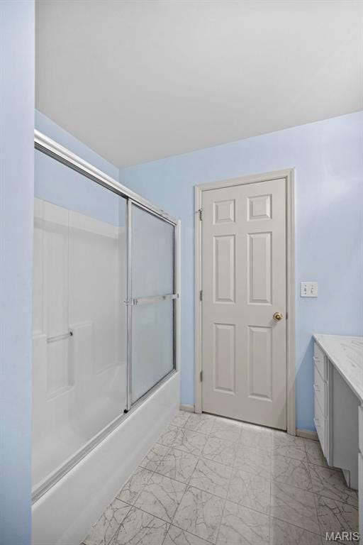 4505 Sherman Park Dr, Saint Charles, MO 63303 - bathroom with marble look tiles, vanity, and enclosed tub / shower combo