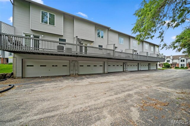 4505 Sherman Park Dr, Saint Charles, MO 63303 - back of house featuring a residential view and a wooden deck