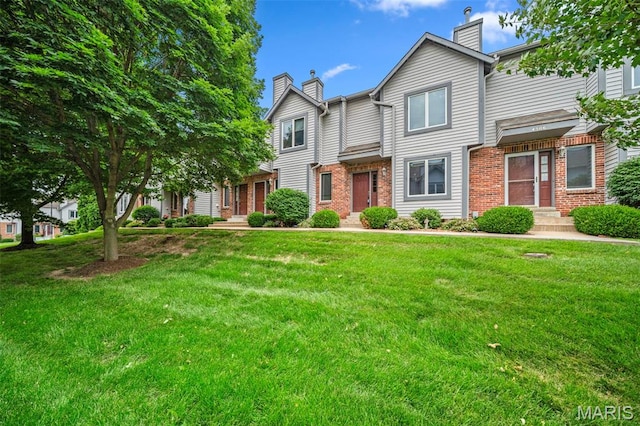 4505 Sherman Park Dr, Saint Charles, MO 63303 - view of property featuring a chimney, brick siding, and a front lawn