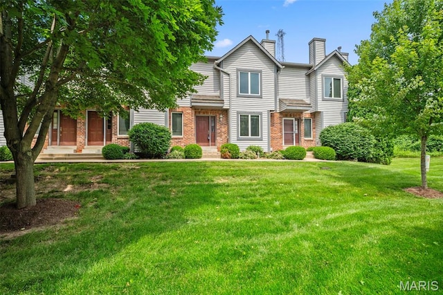 4505 Sherman Park Dr, Saint Charles, MO 63303 - view of front facade with a chimney, brick siding, and a front yard