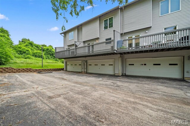 4505 Sherman Park Dr, Saint Charles, MO 63303 - rear view of property featuring a garage