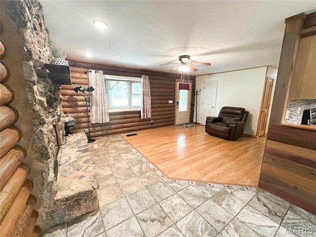 1 Timber Ln, Salem, MO 65560 - living room featuring rustic walls, a ceiling fan, and stone tile flooring