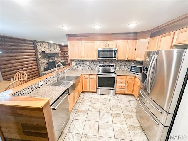 1 Timber Ln, Salem, MO 65560 - kitchen with stainless steel appliances, light brown cabinetry, a peninsula, and rustic walls