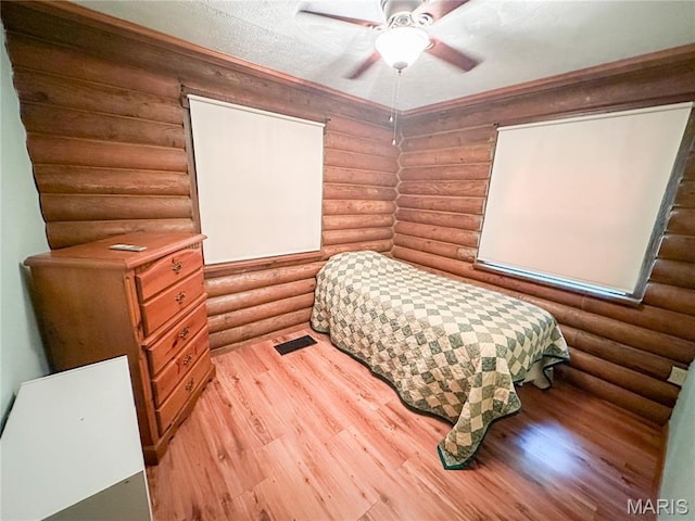 1 Timber Ln, Salem, MO 65560 - bedroom with rustic walls, light wood finished floors, and a ceiling fan