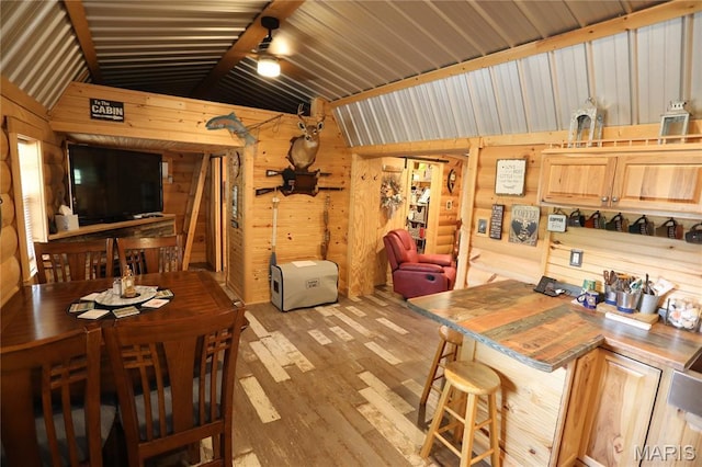 80 Lakeview Dr, Wappapello, MO 63966 - dining area with lofted ceiling, wooden walls, and light wood-style flooring