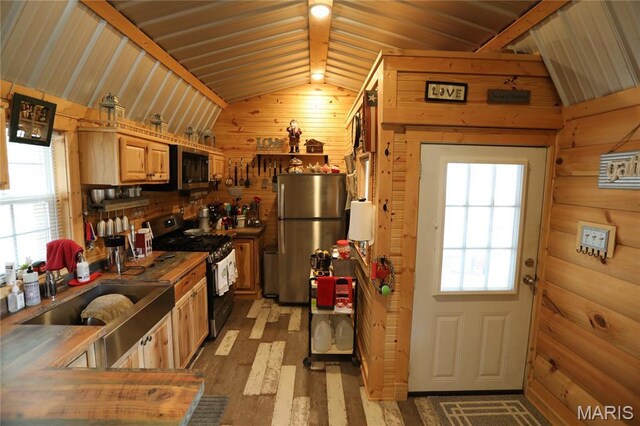 80 Lakeview Dr, Wappapello, MO 63966 - kitchen featuring stainless steel appliances, lofted ceiling, wood walls, a sink, and wood finished floors