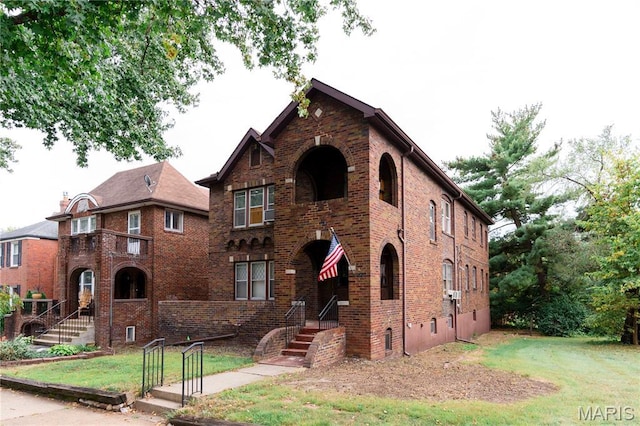 7360 Dartmouth Ave, University City, MO 63130 - tudor-style house featuring a front yard and brick siding