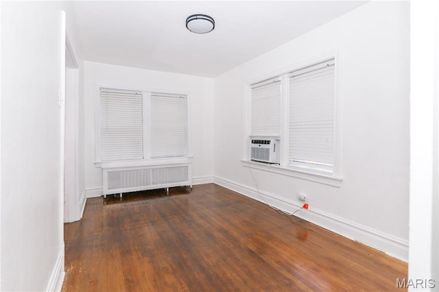 7360 Dartmouth Ave, University City, MO 63130 - empty room with cooling unit, radiator, and wood finished floors