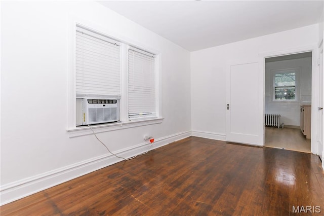 7360 Dartmouth Ave, University City, MO 63130 - unfurnished room with radiator heating unit, wood finished floors, and cooling unit