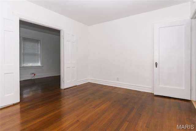 7360 Dartmouth Ave, University City, MO 63130 - spare room with dark wood-style flooring and baseboards