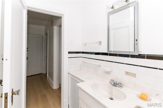 7360 Dartmouth Ave, University City, MO 63130 - bathroom with vanity, wood finished floors, and tasteful backsplash