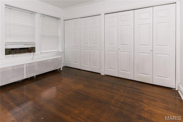 7360 Dartmouth Ave, University City, MO 63130 - unfurnished bedroom with dark wood-style flooring, radiator, two closets, ornamental molding, and cooling unit