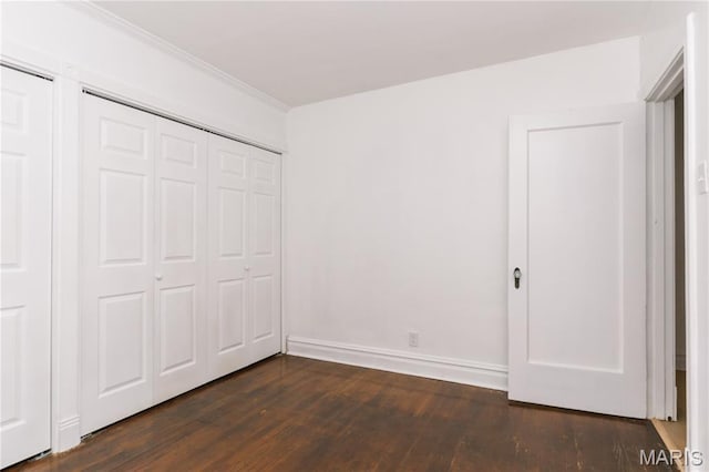 7360 Dartmouth Ave, University City, MO 63130 - unfurnished bedroom featuring dark wood-style flooring, crown molding, and a closet