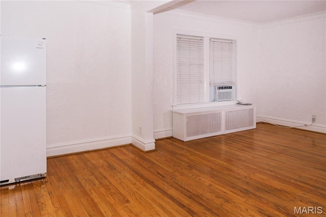 7360 Dartmouth Ave, University City, MO 63130 - spare room featuring radiator heating unit, wood finished floors, and crown molding