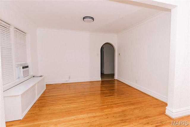 7360 Dartmouth Ave, University City, MO 63130 - spare room with crown molding, arched walkways, light wood-style flooring, and cooling unit