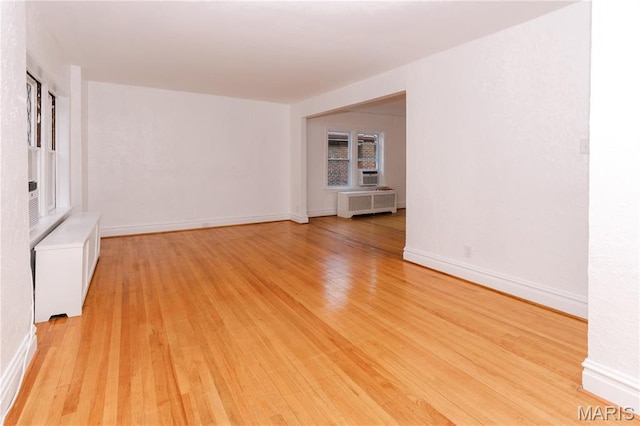 7360 Dartmouth Ave, University City, MO 63130 - spare room featuring radiator heating unit and light wood finished floors