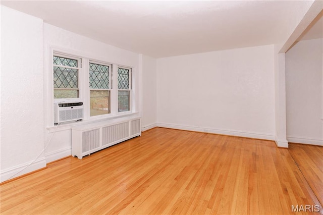 7360 Dartmouth Ave, University City, MO 63130 - spare room with radiator, wood finished floors, and cooling unit