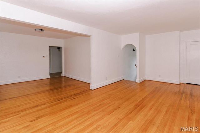 7360 Dartmouth Ave, University City, MO 63130 - unfurnished room with arched walkways and light wood-style floors