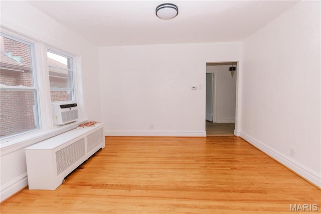 7360 Dartmouth Ave, University City, MO 63130 - spare room with radiator heating unit, light wood finished floors, and cooling unit