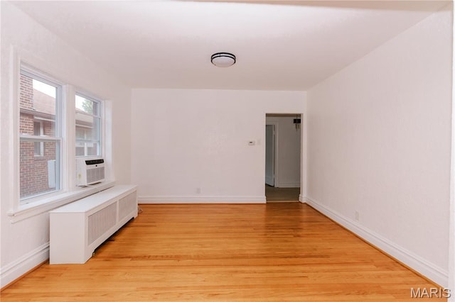 7360 Dartmouth Ave, University City, MO 63130 - empty room featuring light wood finished floors, radiator, and cooling unit