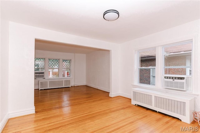 7360 Dartmouth Ave, University City, MO 63130 - unfurnished room featuring radiator heating unit, wood finished floors, and cooling unit