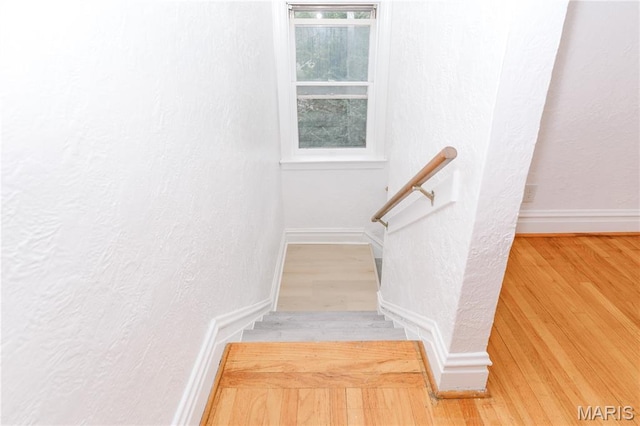 7360 Dartmouth Ave, University City, MO 63130 - staircase featuring wood finished floors and a textured wall