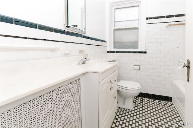 7360 Dartmouth Ave, University City, MO 63130 - full bath with tile walls, vanity, tile patterned floors, and a wainscoted wall