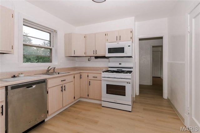 7360 Dartmouth Ave, University City, MO 63130 - kitchen featuring white appliances, light countertops, and light wood-style floors