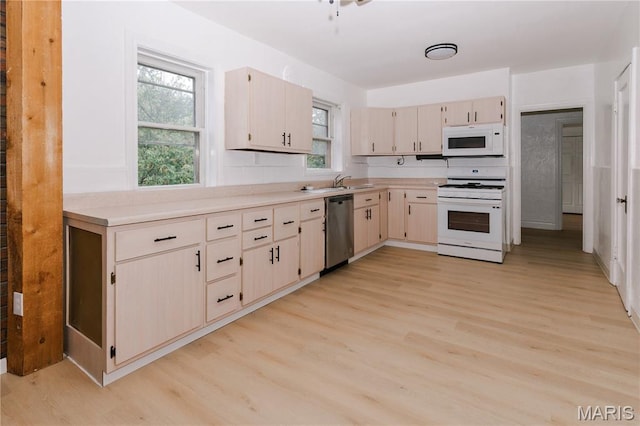 7360 Dartmouth Ave, University City, MO 63130 - kitchen with white appliances, light wood-type flooring, light countertops, and healthy amount of natural light