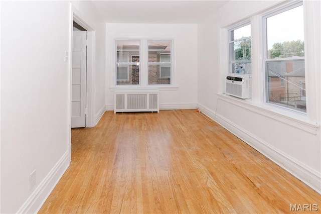 7360 Dartmouth Ave, University City, MO 63130 - empty room with radiator, wood finished floors, and cooling unit
