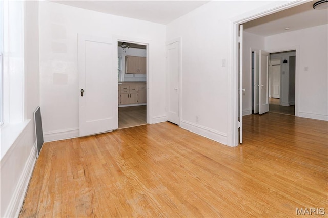 7360 Dartmouth Ave, University City, MO 63130 - empty room with light wood finished floors and baseboards