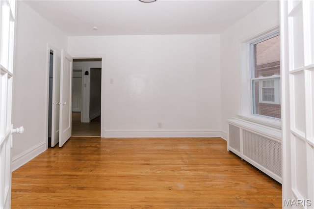 7360 Dartmouth Ave, University City, MO 63130 - empty room with radiator and light wood-style floors