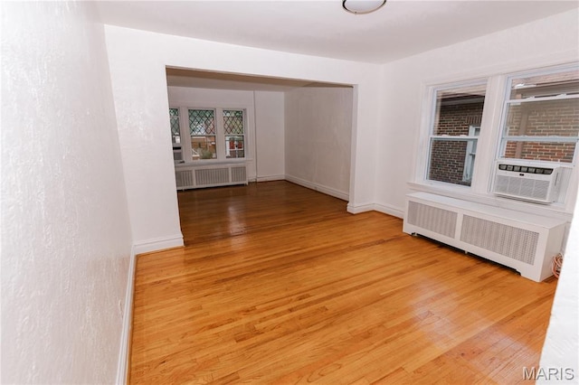 7360 Dartmouth Ave, University City, MO 63130 - spare room featuring radiator heating unit, wood finished floors, and cooling unit