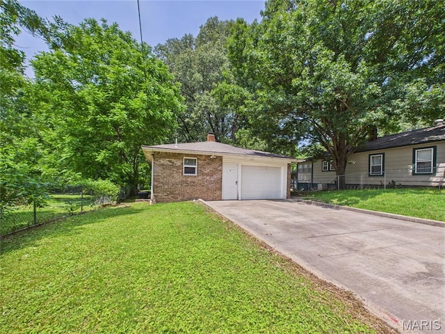 1003 Fay St, Poplar Bluff, MO 63901 - view of front of house with brick siding, driveway, a chimney, and a garage