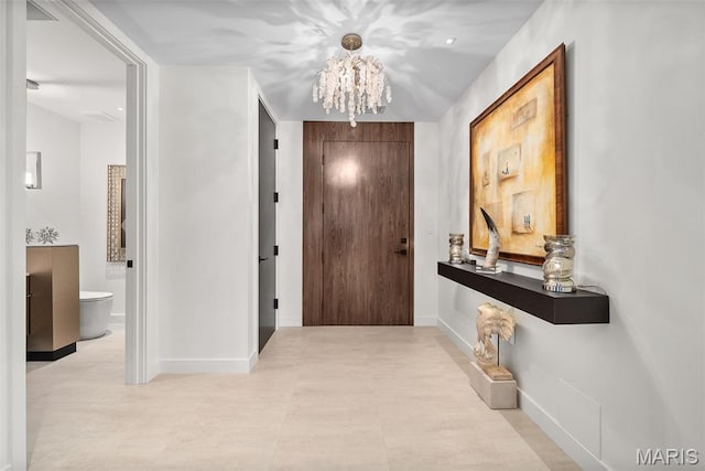 150 Carondelet Plz Unit 702, Clayton, MO 63105 - foyer entrance featuring a chandelier and baseboards