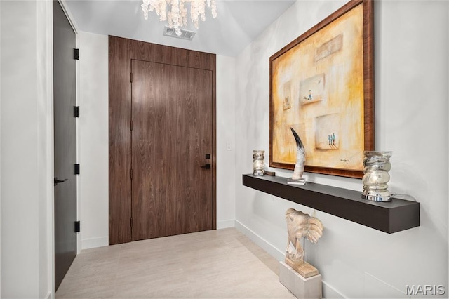 150 Carondelet Plz Unit 702, Clayton, MO 63105 - entryway featuring baseboards and a chandelier