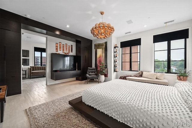 150 Carondelet Plz Unit 702, Clayton, MO 63105 - bedroom featuring a chandelier, recessed lighting, and light wood-type flooring