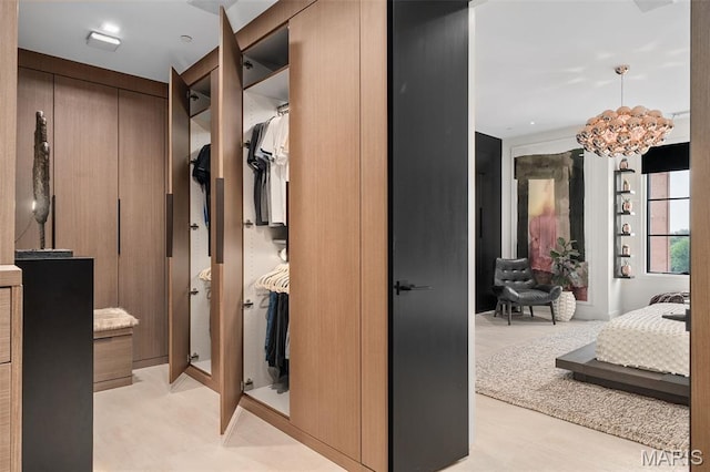 150 Carondelet Plz Unit 702, Clayton, MO 63105 - bathroom with a spacious closet and a chandelier