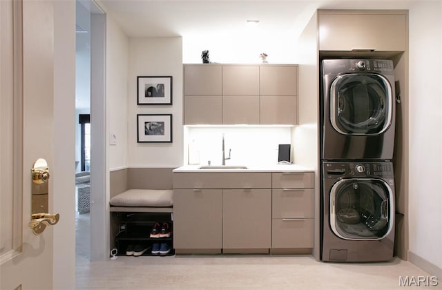 150 Carondelet Plz Unit 702, Clayton, MO 63105 - laundry room featuring stacked washing machine and dryer and light wood finished floors