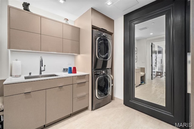 150 Carondelet Plz Unit 702, Clayton, MO 63105 - laundry area with stacked washer / drying machine and cabinet space