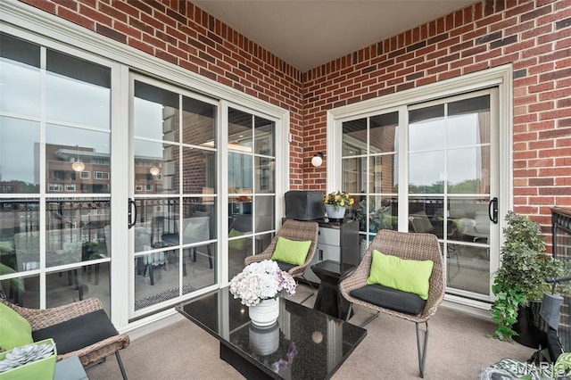 150 Carondelet Plz Unit 702, Clayton, MO 63105 - sunroom / solarium with brick wall and carpet
