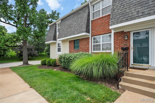 9177 Robin Ct, Brentwood, MO 63144 - view of property exterior featuring brick siding, a shingled roof, mansard roof, and a lawn
