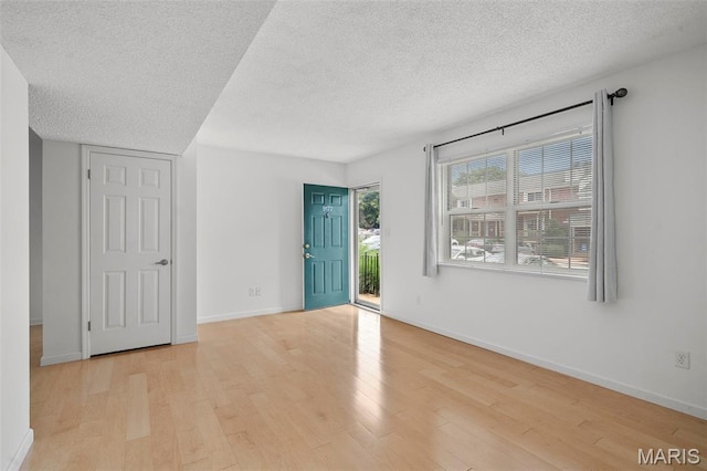 9177 Robin Ct, Brentwood, MO 63144 - empty room featuring wood finished floors, a textured ceiling, and baseboards